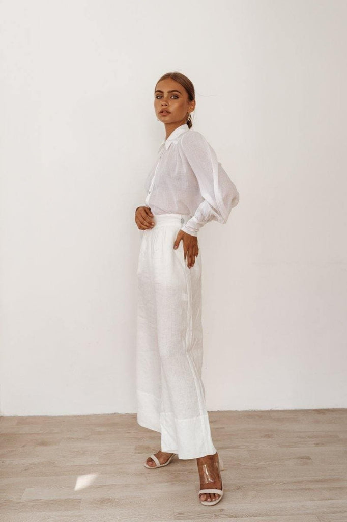 fashion model in a linen shirt and elegant white pants